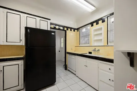 a kitchen with a refrigerator and a sink