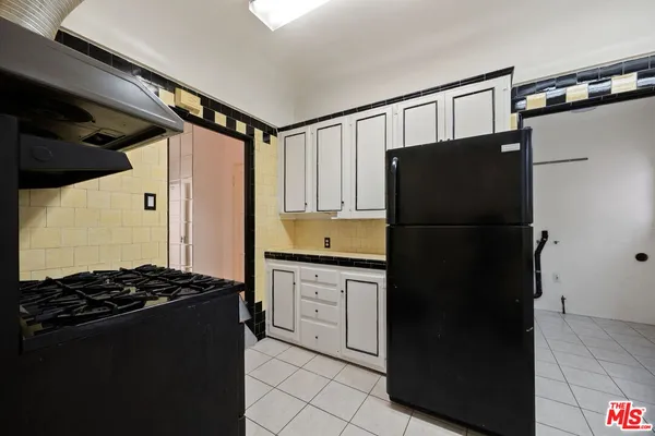 a kitchen with a refrigerator and a stove