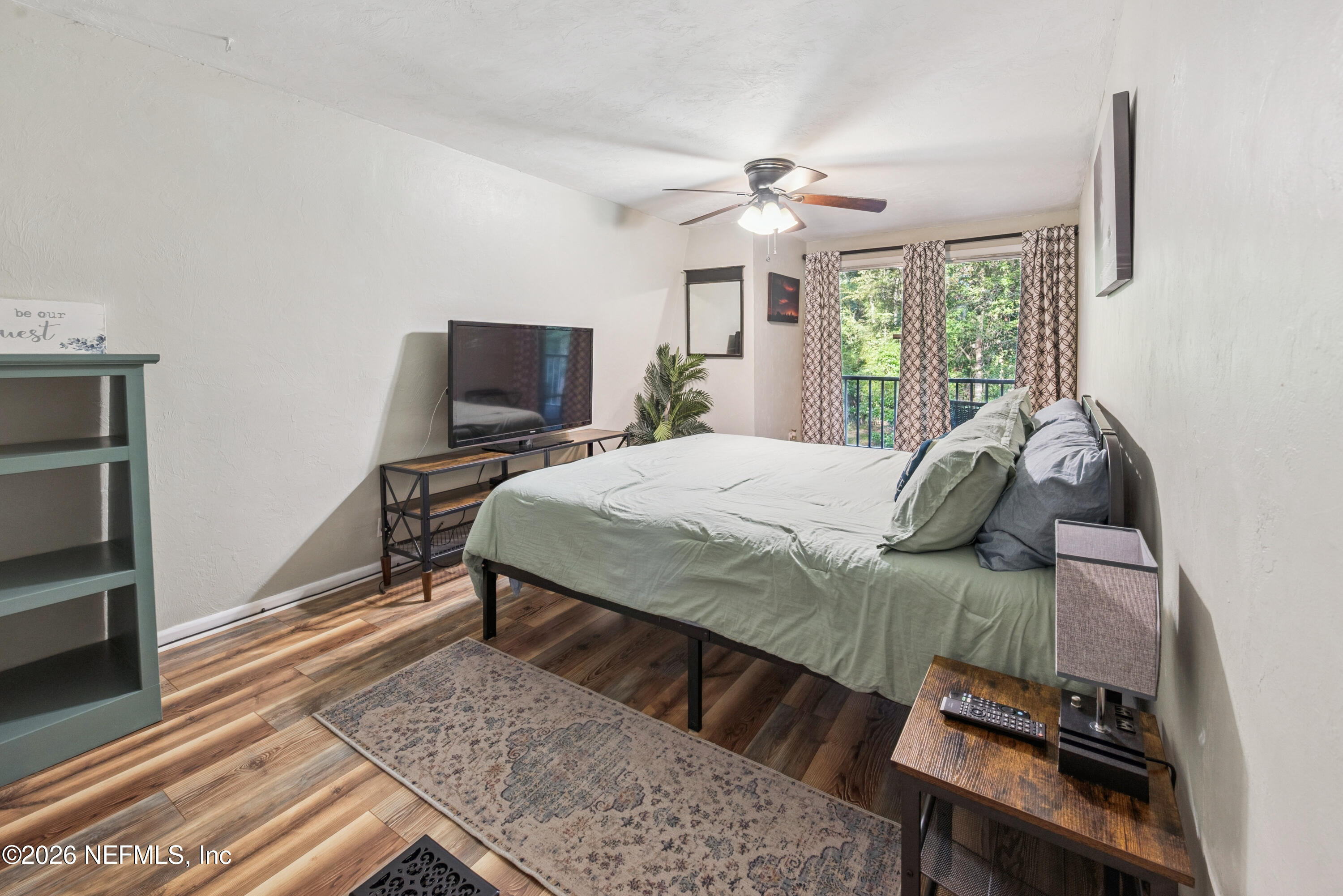 141 Southwest Longhorn Terrace Fort White, FL 32038 - Photo 13 of 31 a bedroom with a bed and wooden floor