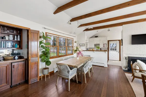 a view of a dining room with furniture window and wooden floor