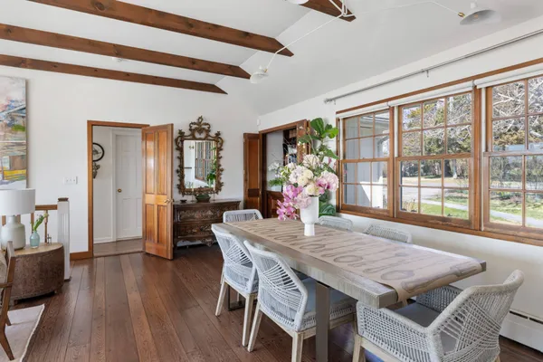 a dining room with furniture and wooden floor