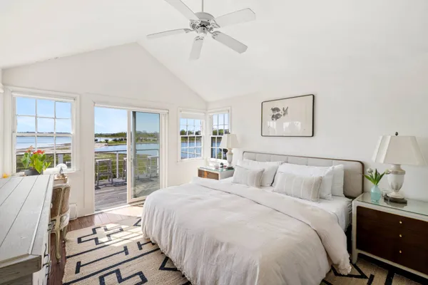 a bedroom with bed and wooden floor