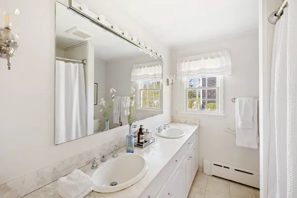 a bathroom with a sink a mirror and a shower