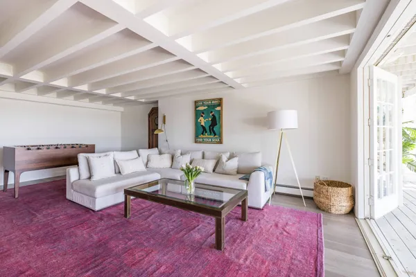 a living room with furniture rug and window