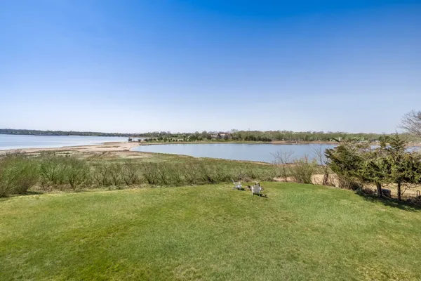 a view of a lake with houses in the back
