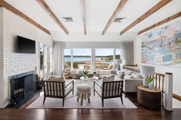 a view of a livingroom with furniture window and wooden floor