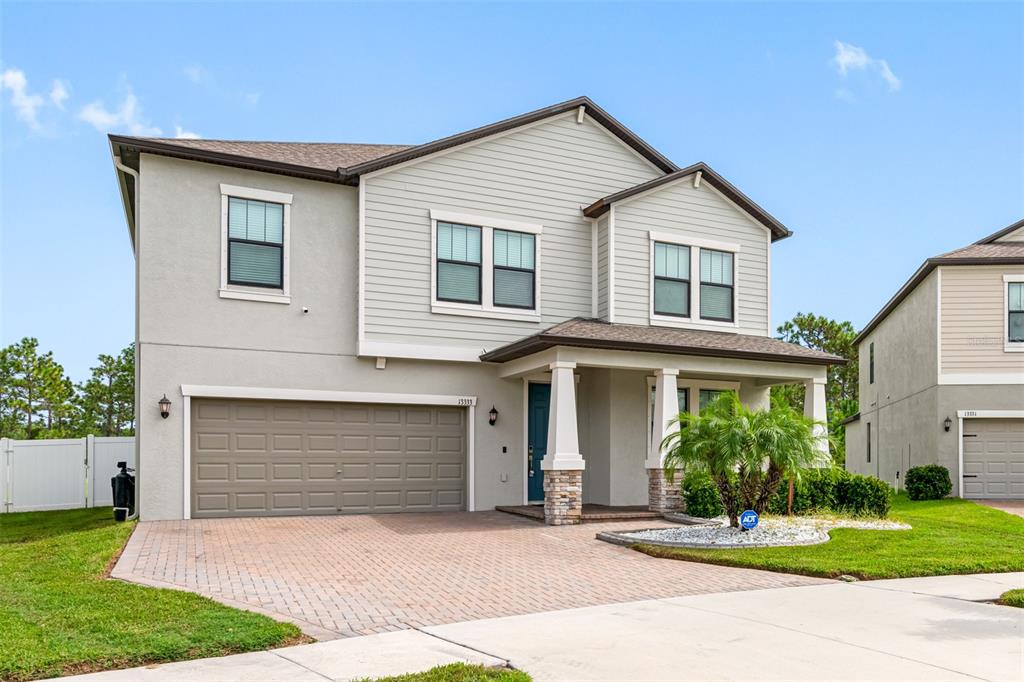 a front view of a house with a yard and garage