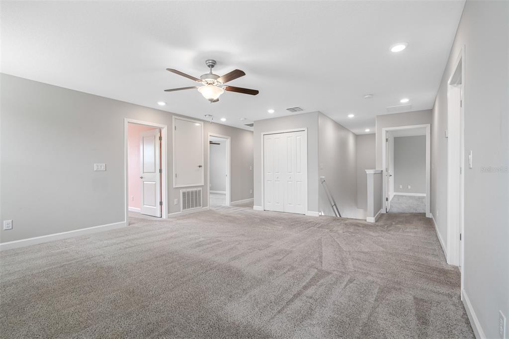 13333 Orca Sound Drive Riverview, FL 33579 - Photo 12 of 32 a view of an empty room with a ceiling fan