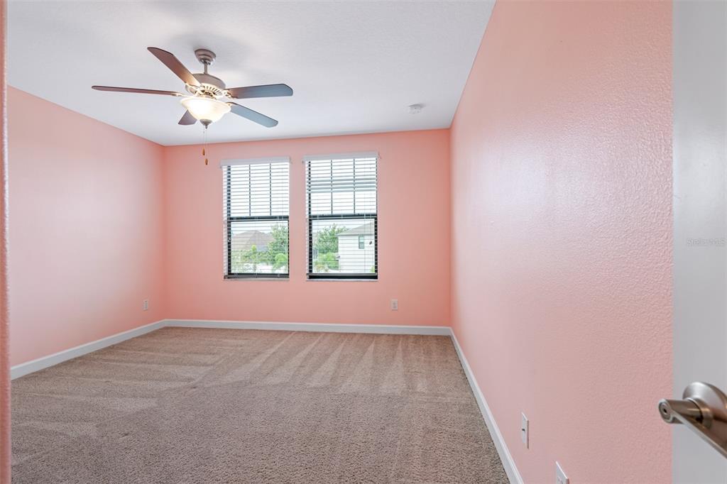 13333 Orca Sound Drive Riverview, FL 33579 - Photo 19 of 32 an empty room with windows and fan