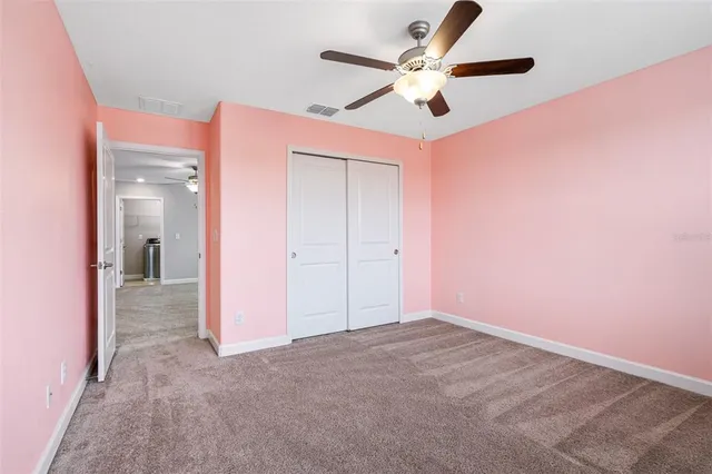 a view of a big room with a ceiling fan and a chandelier fan