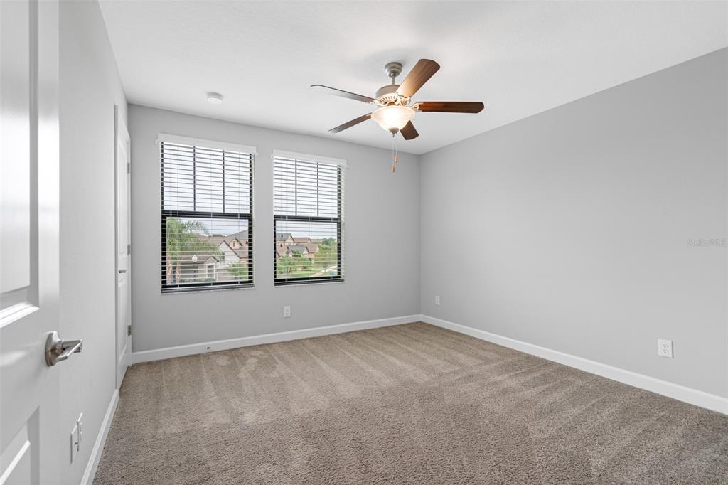 13333 Orca Sound Drive Riverview, FL 33579 - Photo 21 of 32 an empty room with windows and fan