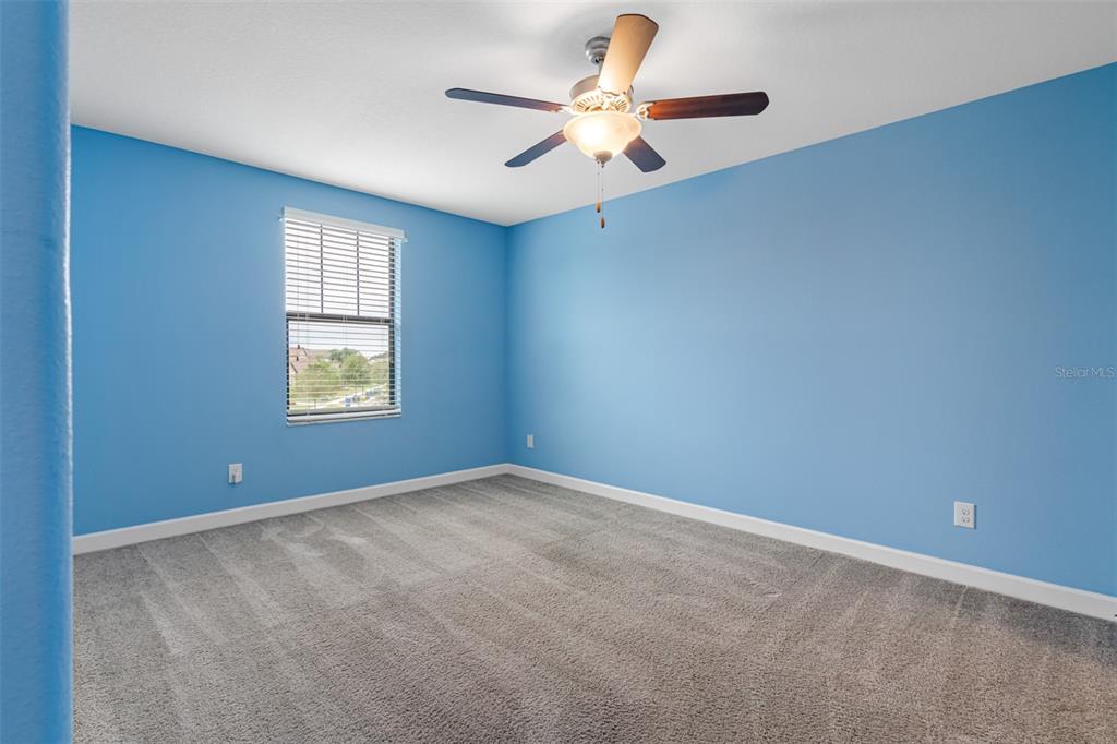 13333 Orca Sound Drive Riverview, FL 33579 - Photo 24 of 32 an empty room with windows and fan