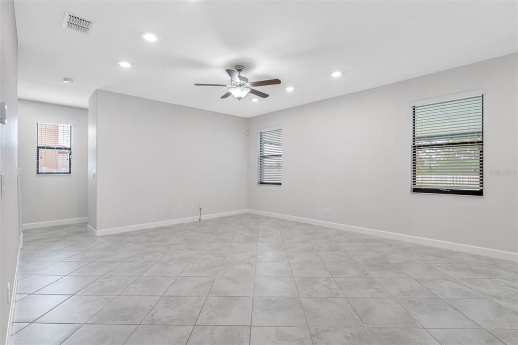 13333 Orca Sound Drive Riverview, FL 33579 - Photo 5 of 32 an empty room with windows and fan