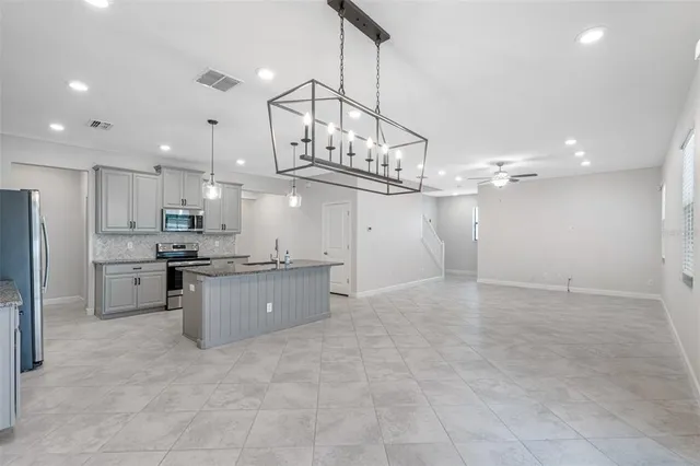 a large kitchen with cabinets and stainless steel appliances