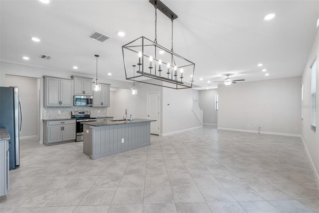 13333 Orca Sound Drive Riverview, FL 33579 - Photo 7 of 32 a large kitchen with cabinets and stainless steel appliances