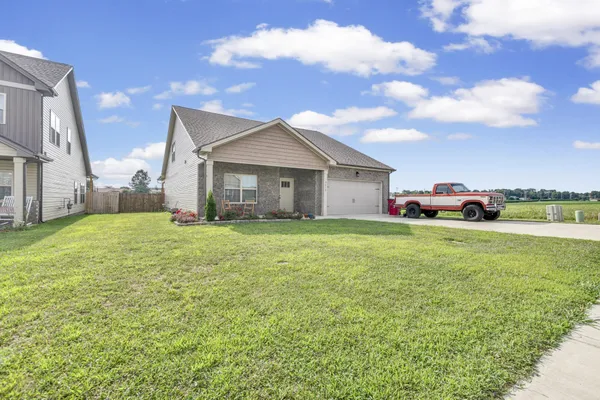 a front view of house with yard and green space