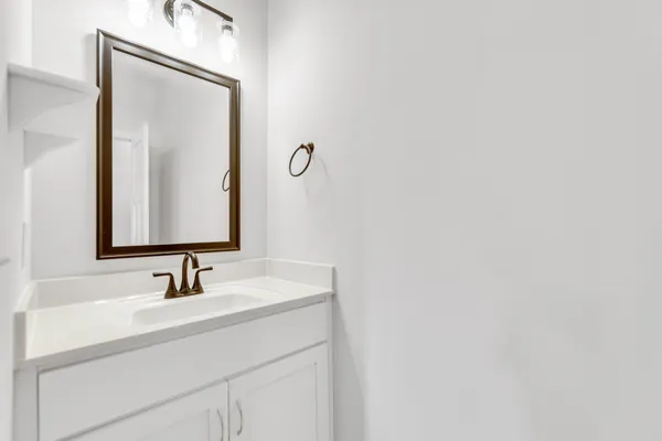 a bathroom with a sink vanity and a mirror