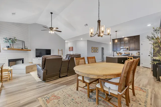 a view of a dining room with furniture wooden floor and chandelier