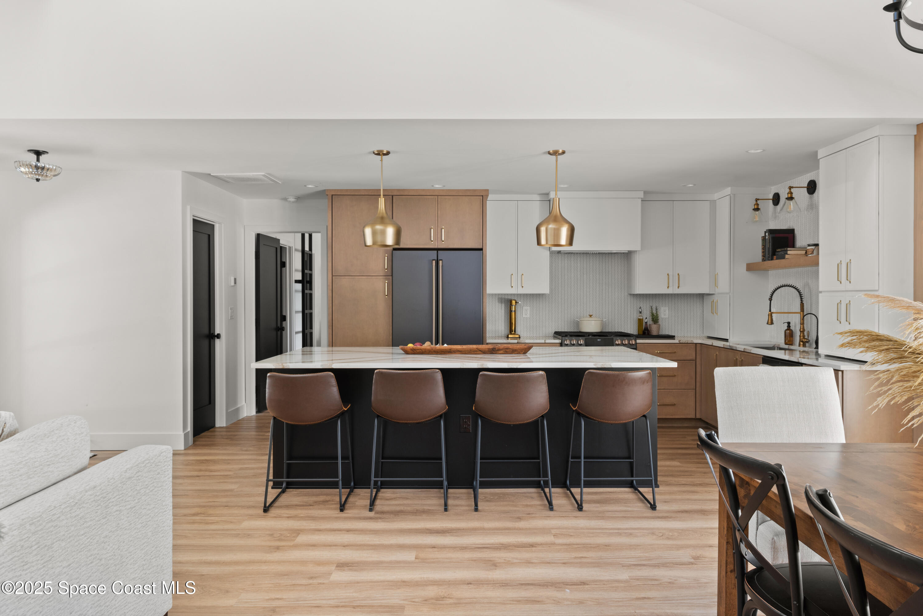 3425 Kent Drive Melbourne, FL 32935 - Photo 11 of 21 a kitchen with a dining table chairs and white stainless steel appliances