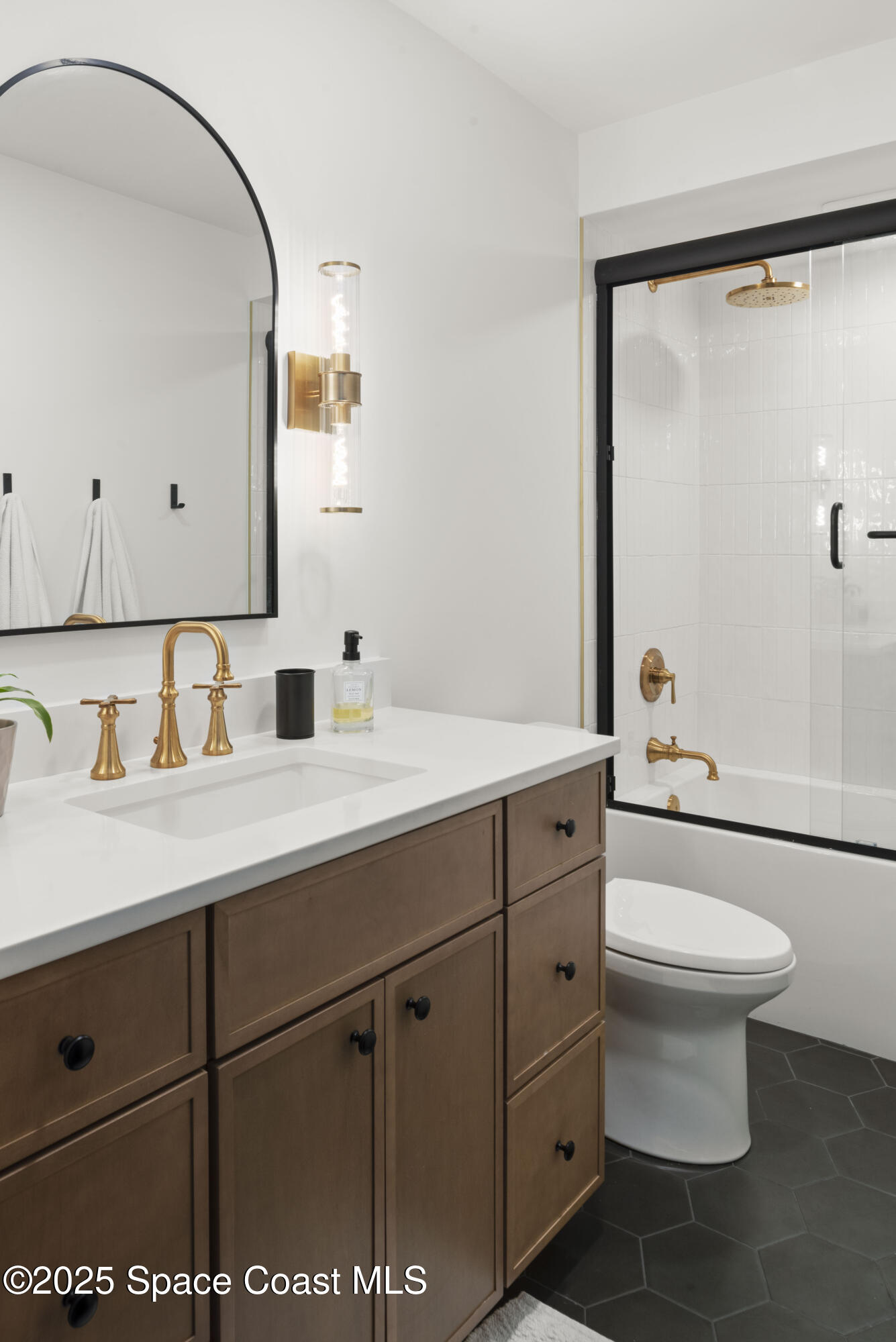 3425 Kent Drive Melbourne, FL 32935 - Photo 20 of 21 a bathroom with a granite countertop sink toilet and mirror