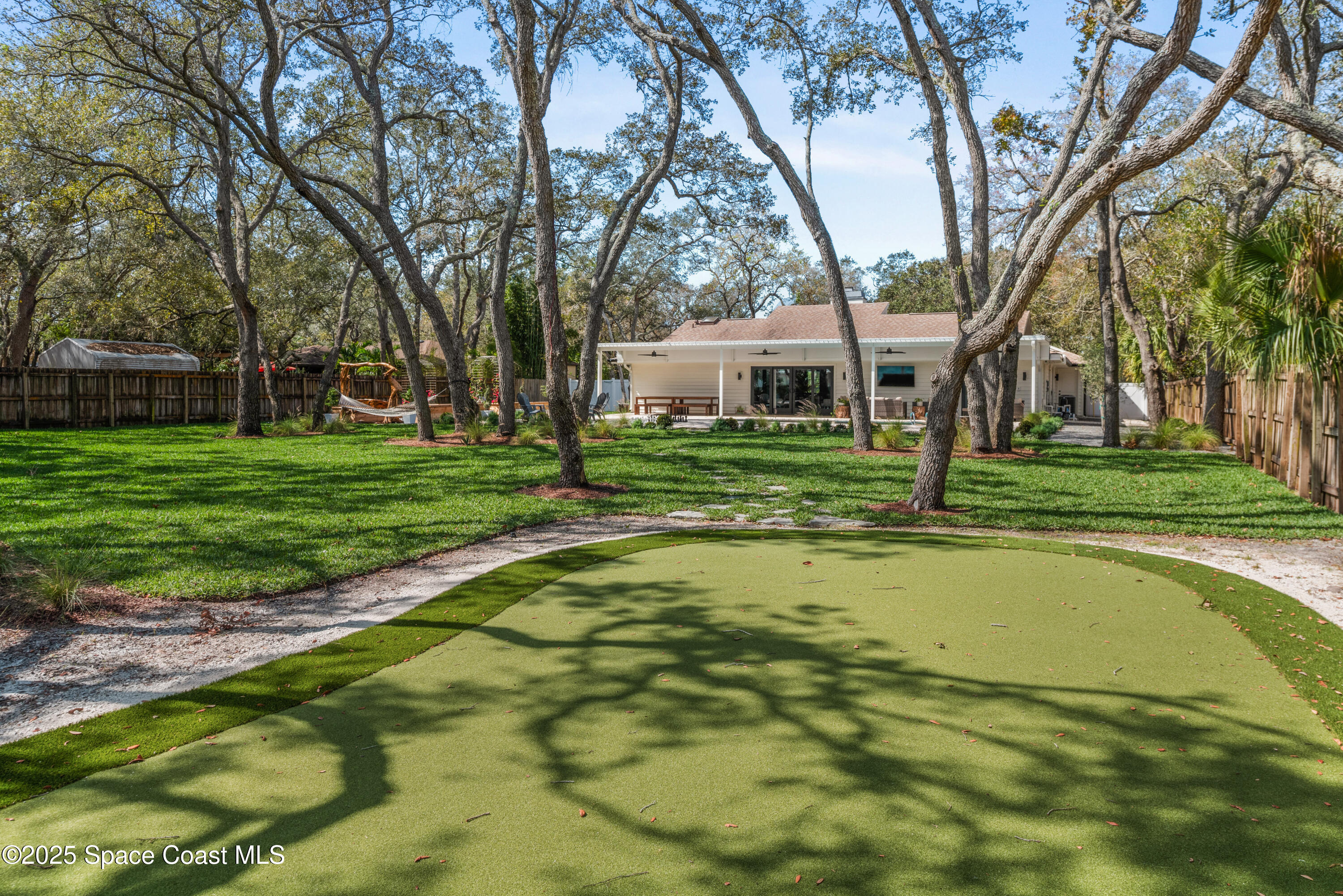 3425 Kent Drive Melbourne, FL 32935 - Photo 6 of 21 a view of a house with a big yard and large trees
