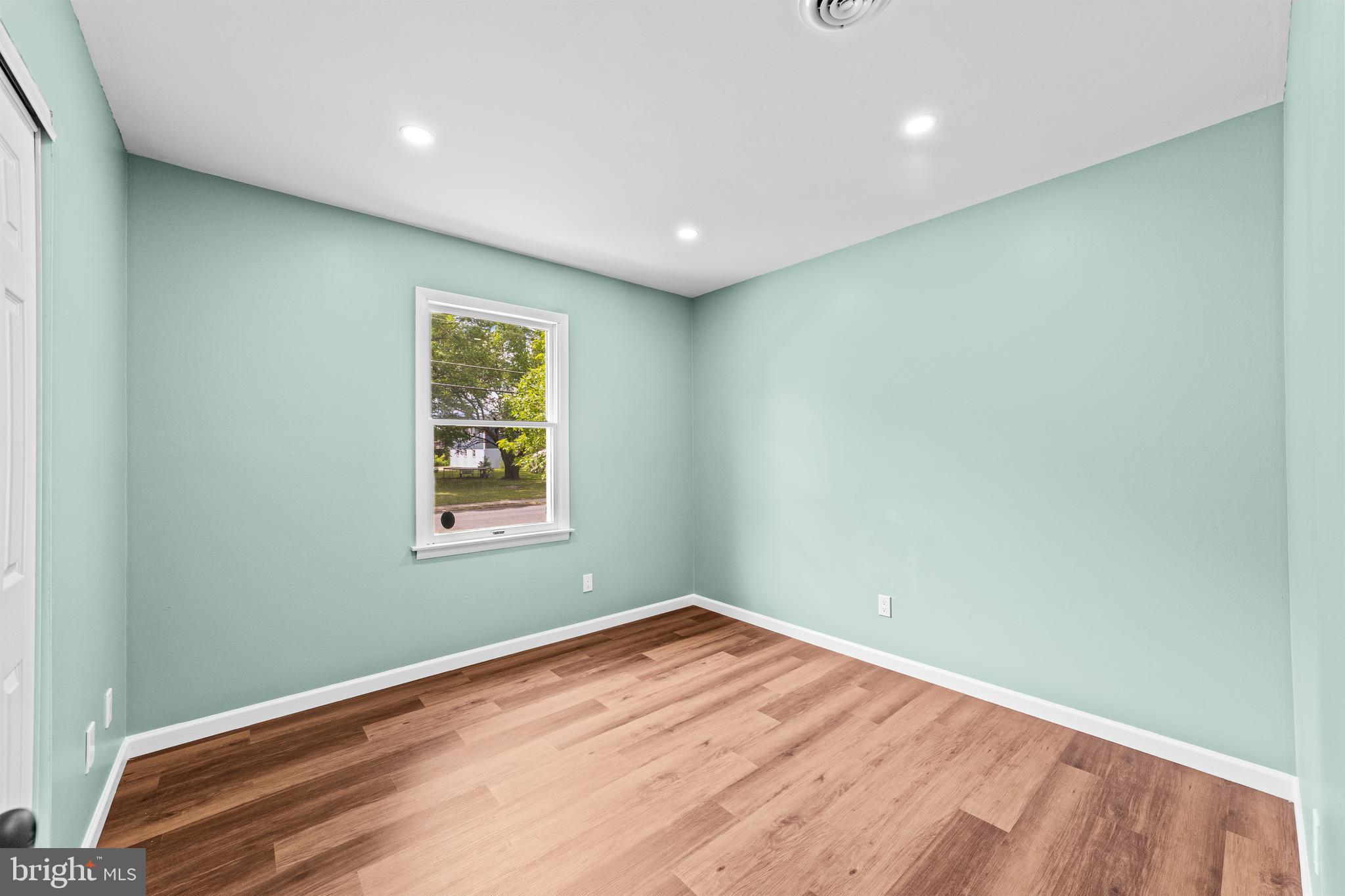 88 Delaware Drive Pennsville, NJ 08070 - Photo 13 of 26 a view of empty room with wooden floor and fan