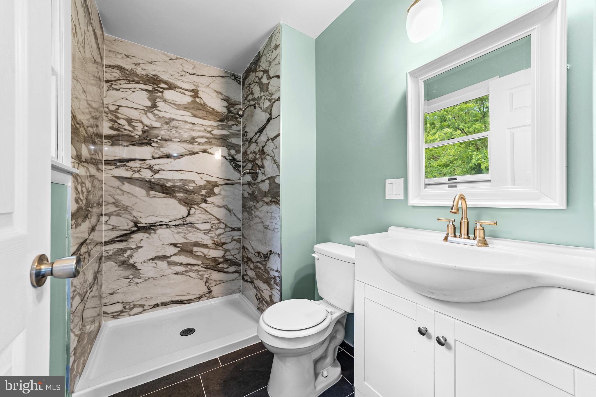 88 Delaware Drive Pennsville, NJ 08070 - Photo 18 of 26 a bathroom with a sink toilet and window