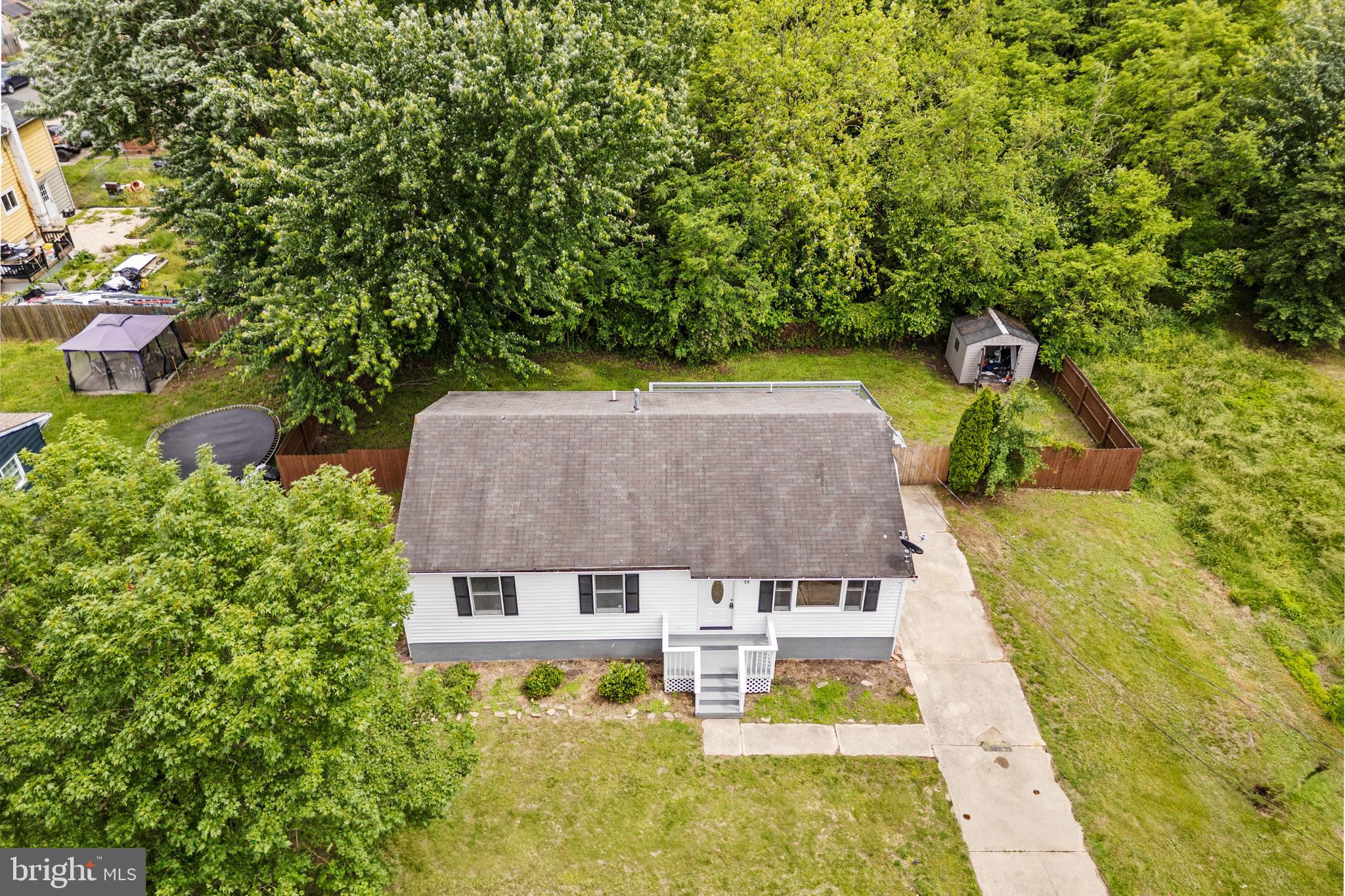 88 Delaware Drive Pennsville, NJ 08070 - Photo 23 of 26 an aerial view of a house with swimming pool and large trees