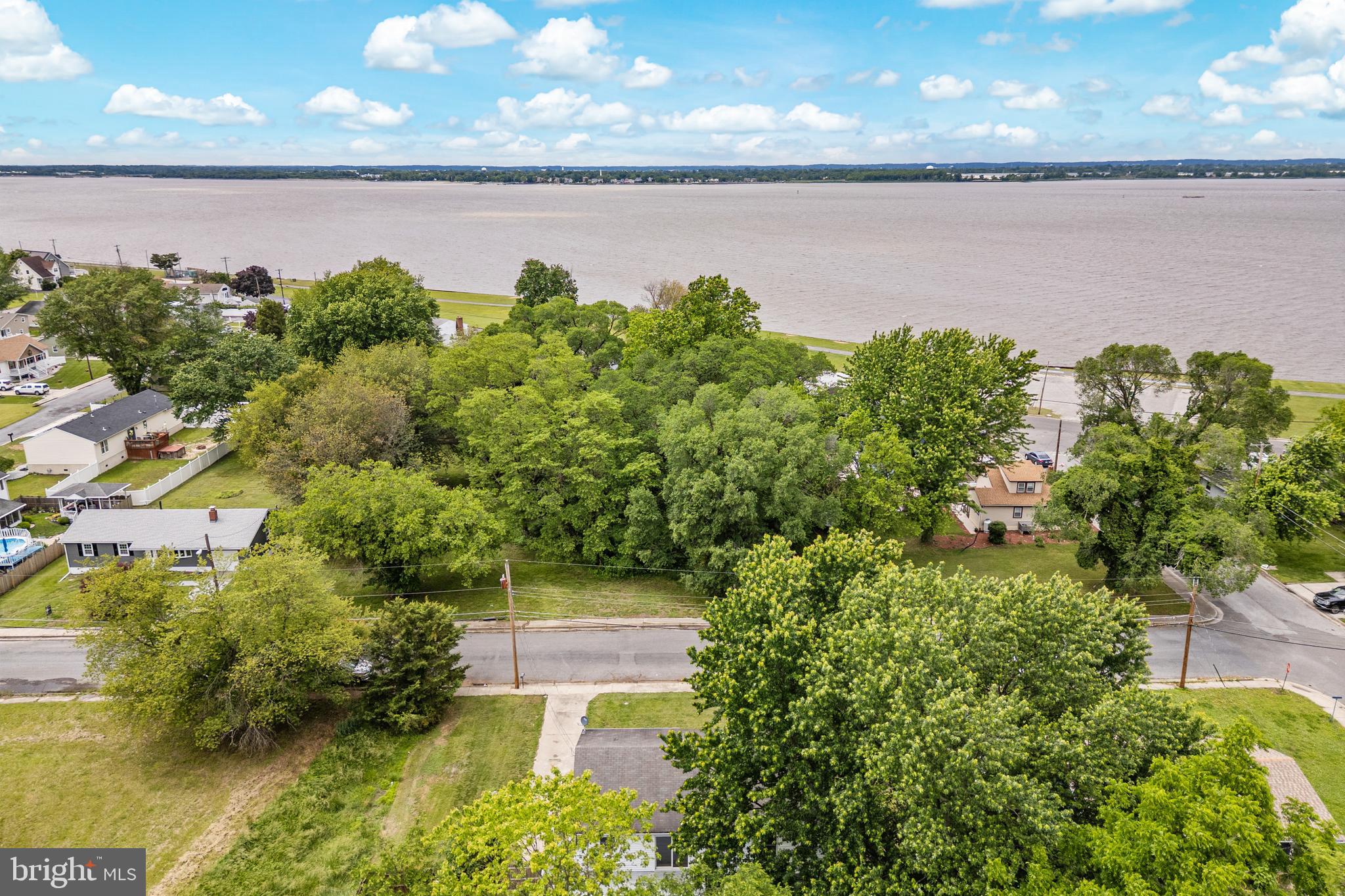 88 Delaware Drive Pennsville, NJ 08070 - Photo 25 of 26 a view of a lake from a yard