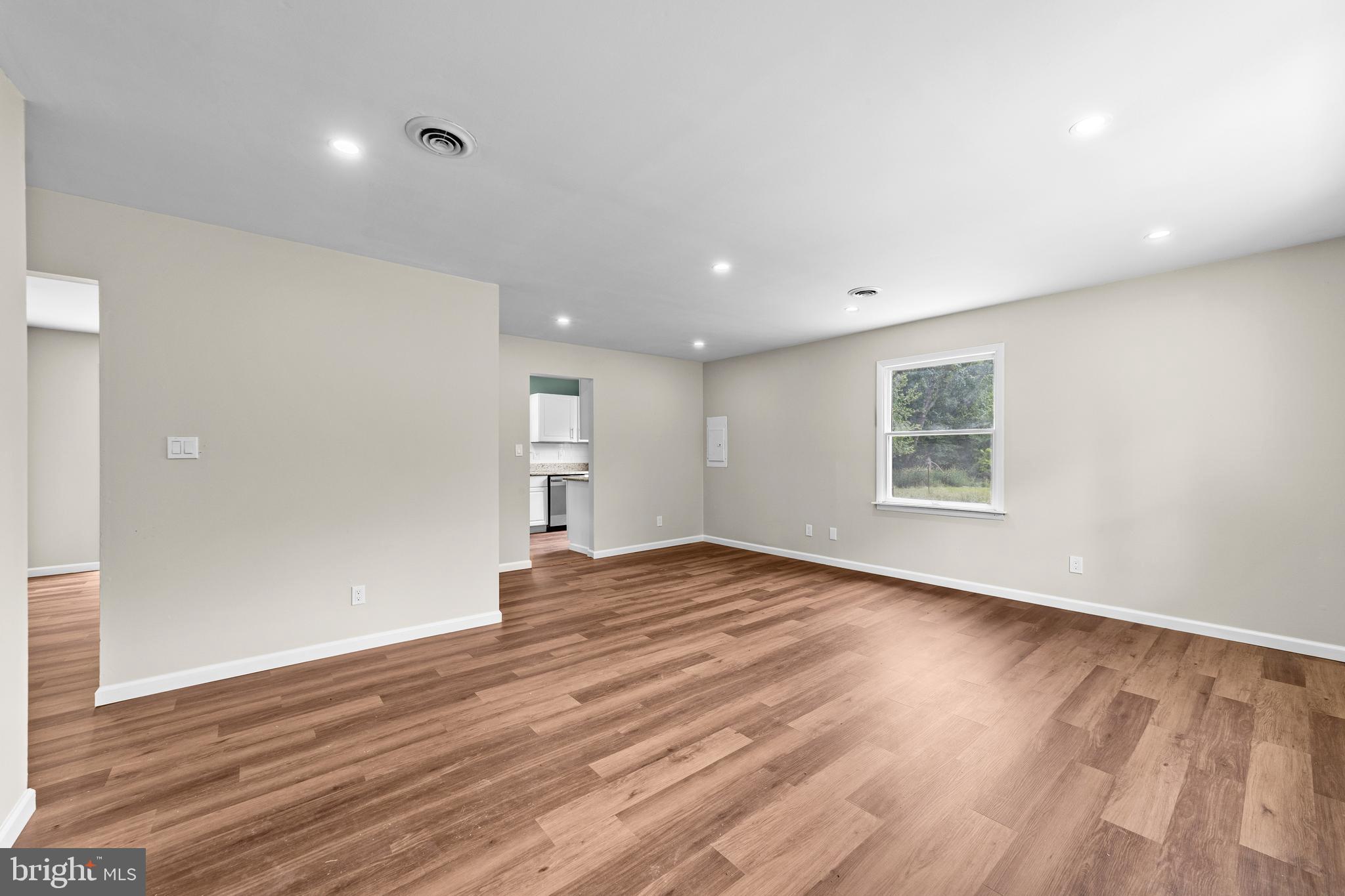 88 Delaware Drive Pennsville, NJ 08070 - Photo 3 of 26 a view of an empty room with wooden floor and a window