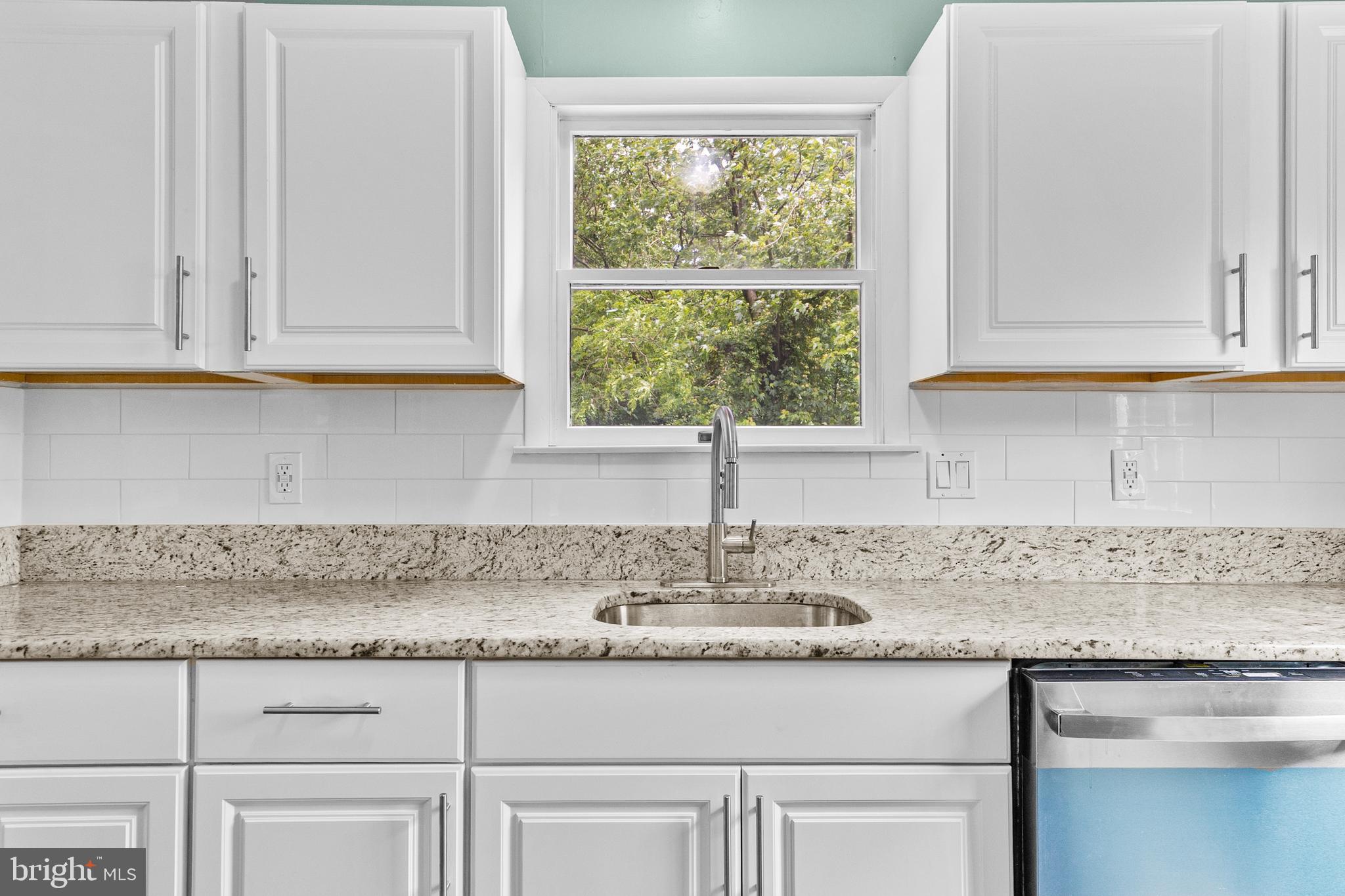 88 Delaware Drive Pennsville, NJ 08070 - Photo 5 of 26 a kitchen with granite countertop white cabinets and a window