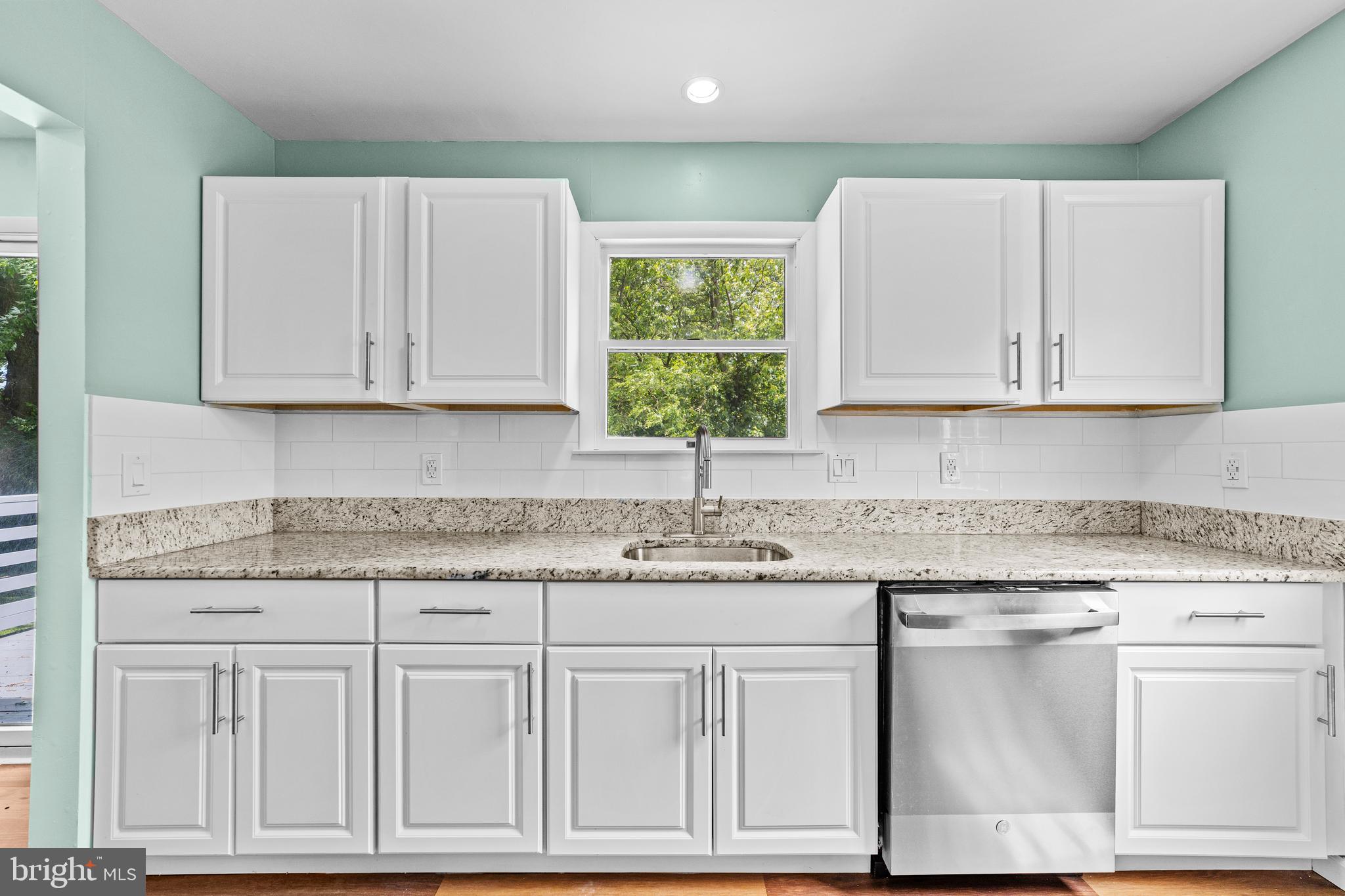 88 Delaware Drive Pennsville, NJ 08070 - Photo 6 of 26 a kitchen with granite countertop white cabinets and a stove