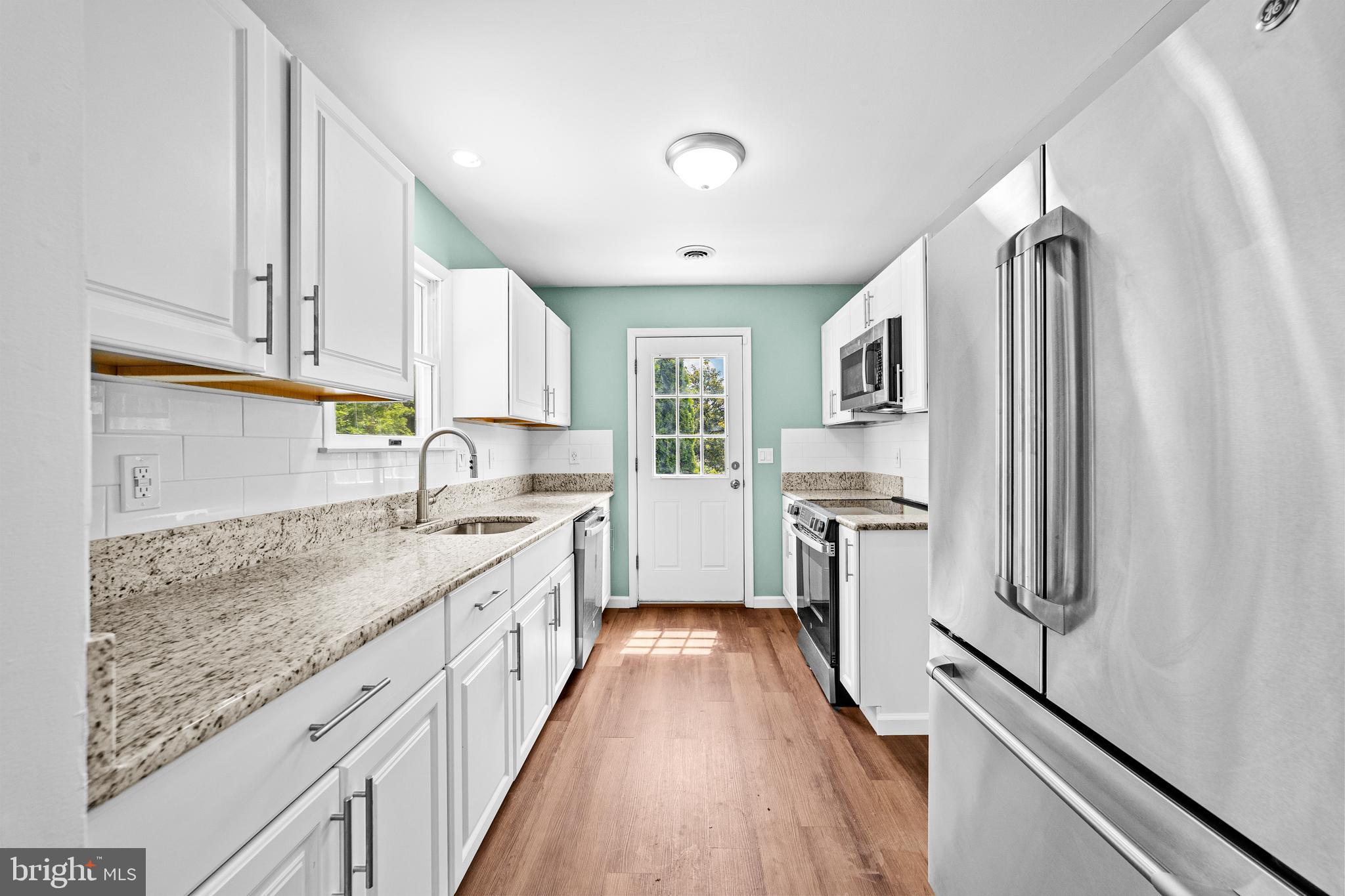 88 Delaware Drive Pennsville, NJ 08070 - Photo 7 of 26 a kitchen with stainless steel appliances granite countertop a sink stove and refrigerator