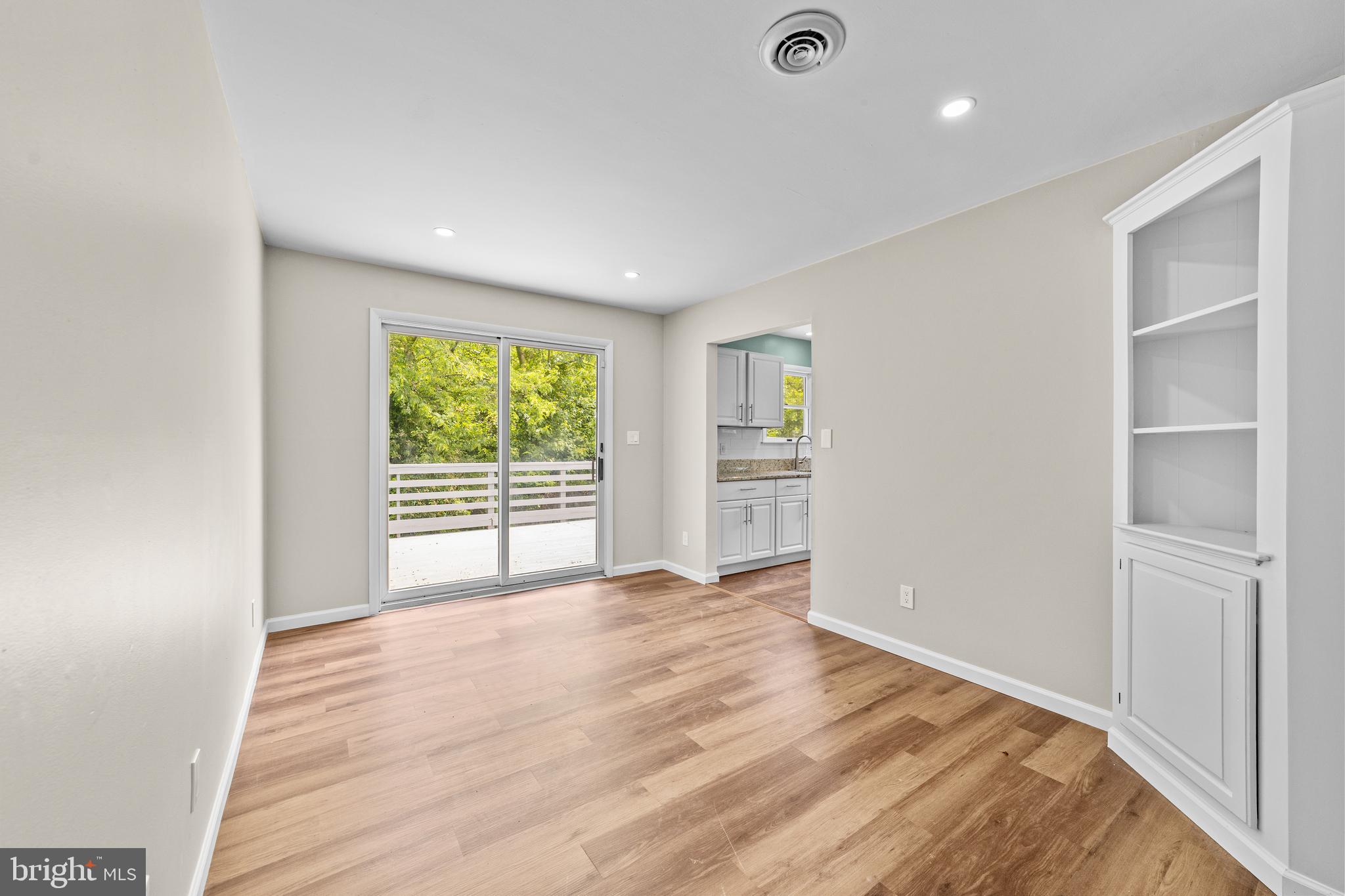 88 Delaware Drive Pennsville, NJ 08070 - Photo 9 of 26 a view of an empty room with a window and wooden floor