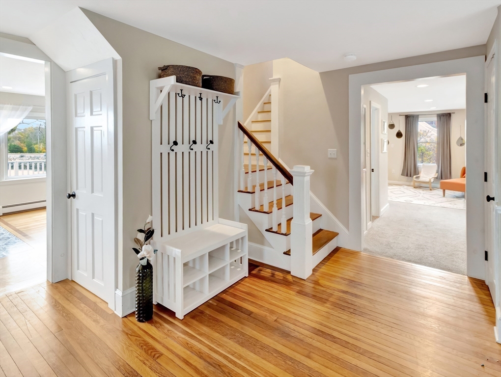 54 Salisbury Street Hull, MA 02045 - Photo 12 of 38 a view of a hallway with entryway wooden floor and front door