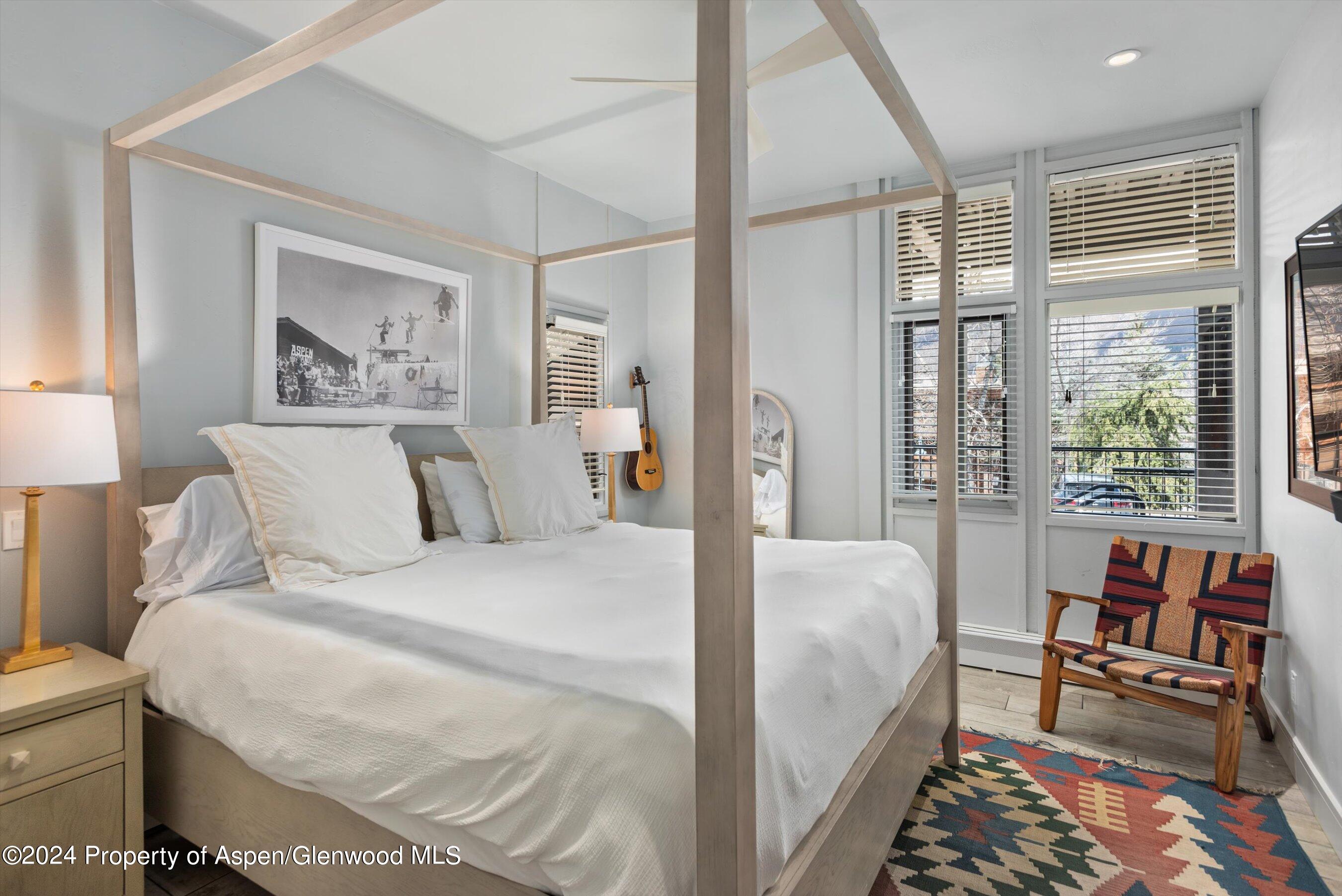 800 South Mill Street, Unit 102C Aspen, CO 81611 - Photo 13 of 23 a bed room with a bed and a chair