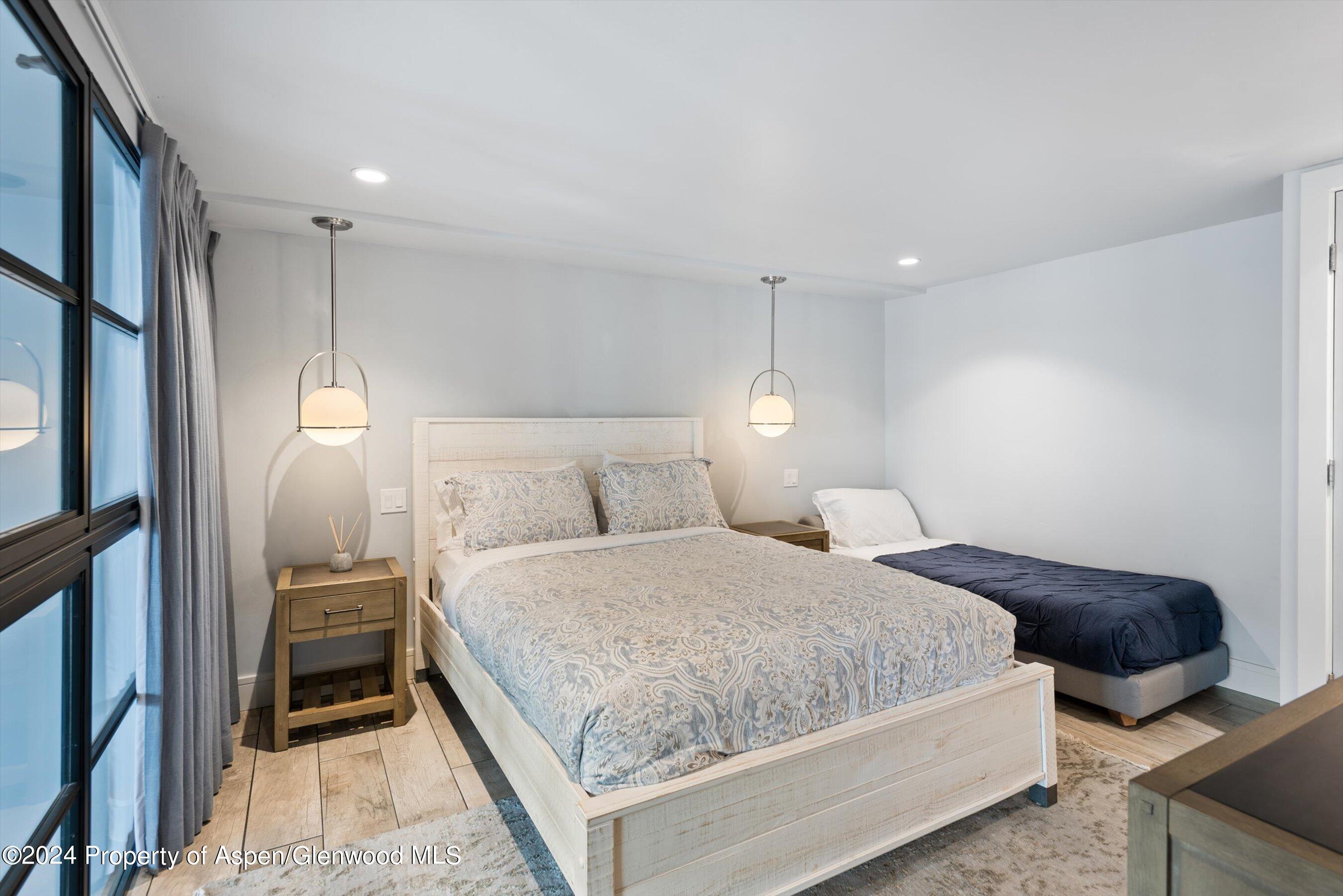 800 South Mill Street, Unit 102C Aspen, CO 81611 - Photo 17 of 23 a bedroom with a bed and a walk in closet