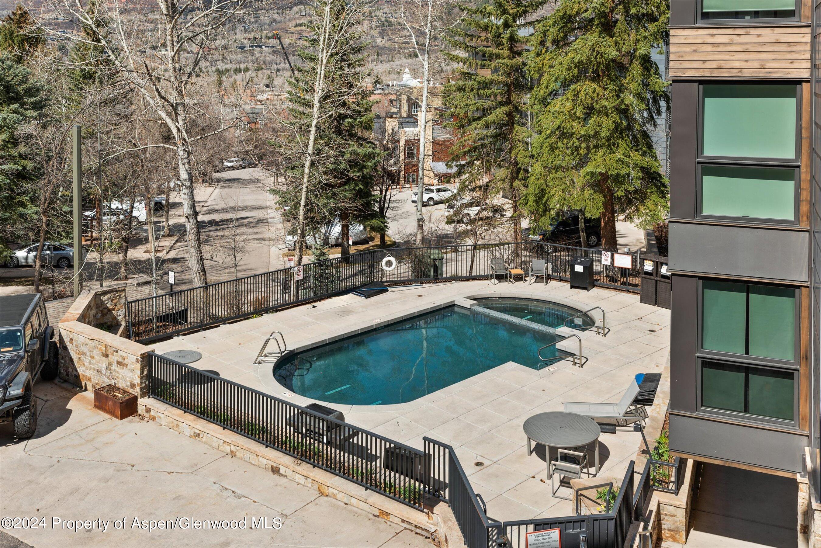 800 South Mill Street, Unit 102C Aspen, CO 81611 - Photo 23 of 23 a swimming pool with outdoor seating and yard