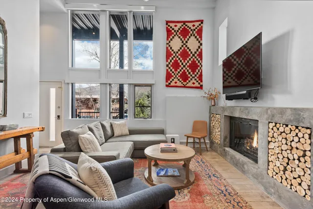 a living room with fireplace furniture and a flat screen tv
