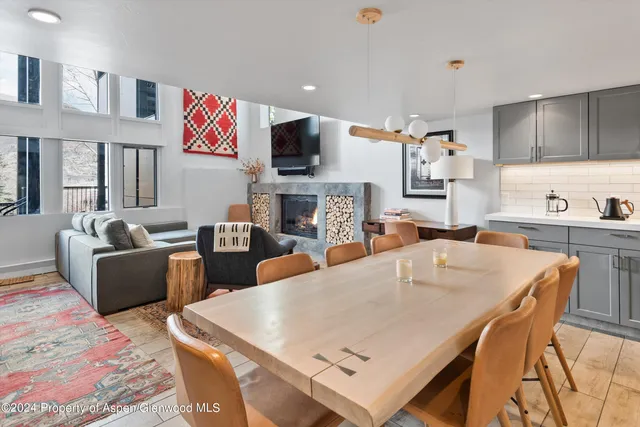 a large kitchen with stainless steel appliances granite countertop a stove a sink dishwasher and a refrigerator with wooden floor