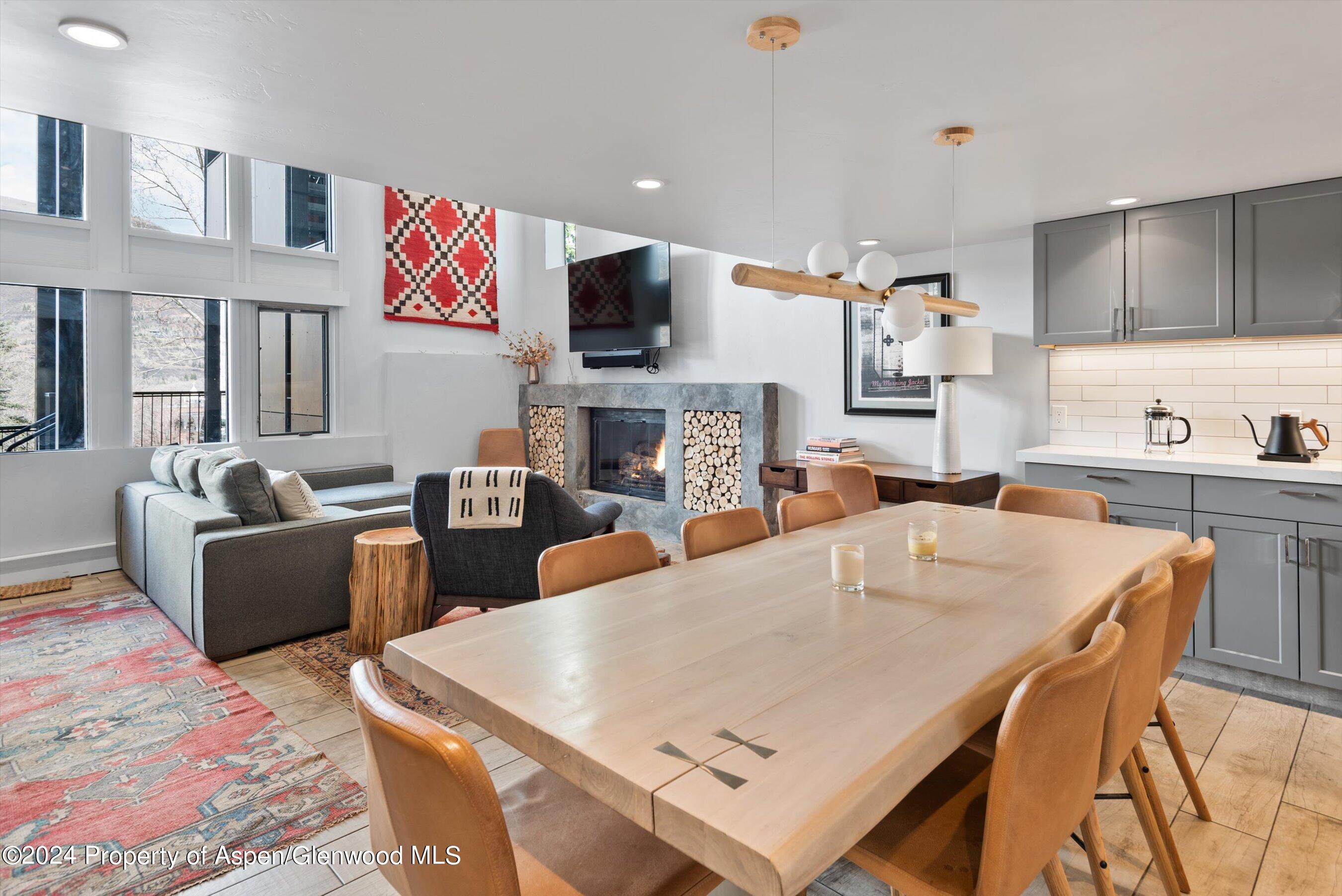 800 South Mill Street, Unit 102C Aspen, CO 81611 - Photo 7 of 23 a living room with furniture a flat screen tv and kitchen view