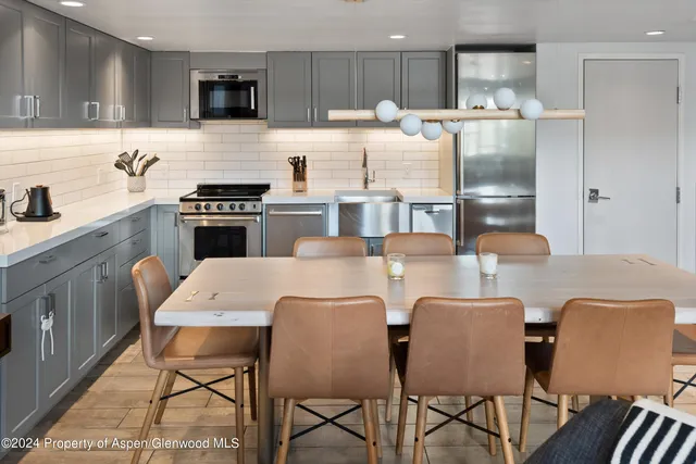 a living room with furniture kitchen view and a window