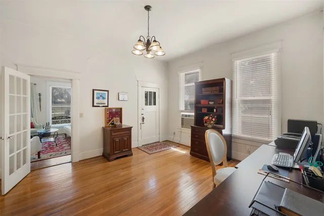 a view of a workspace with furniture and a window