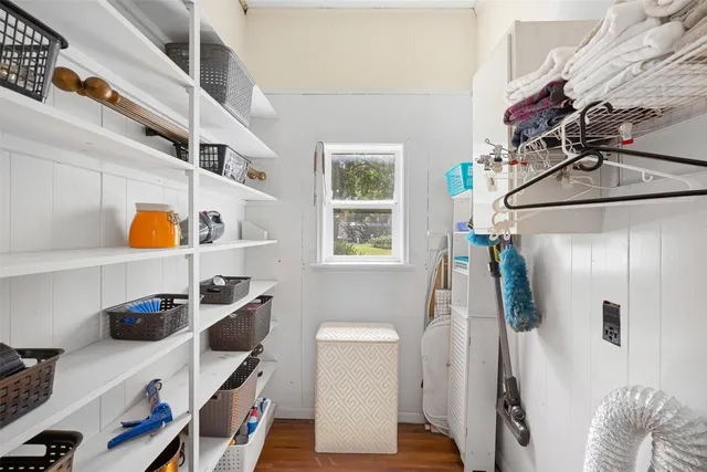 a view of walk in closet with clothes and shoes