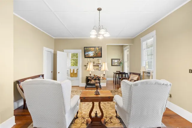 a living room with furniture and a chandelier