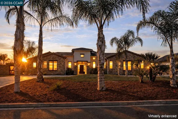 a front view of a building with palm trees