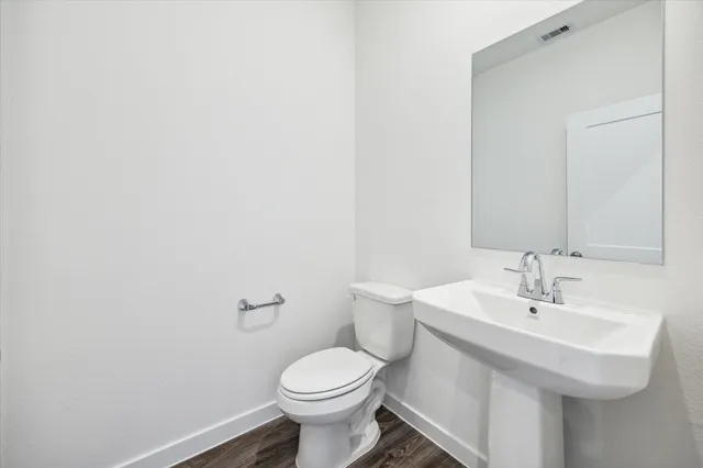 a bathroom with a sink a toilet and mirror
