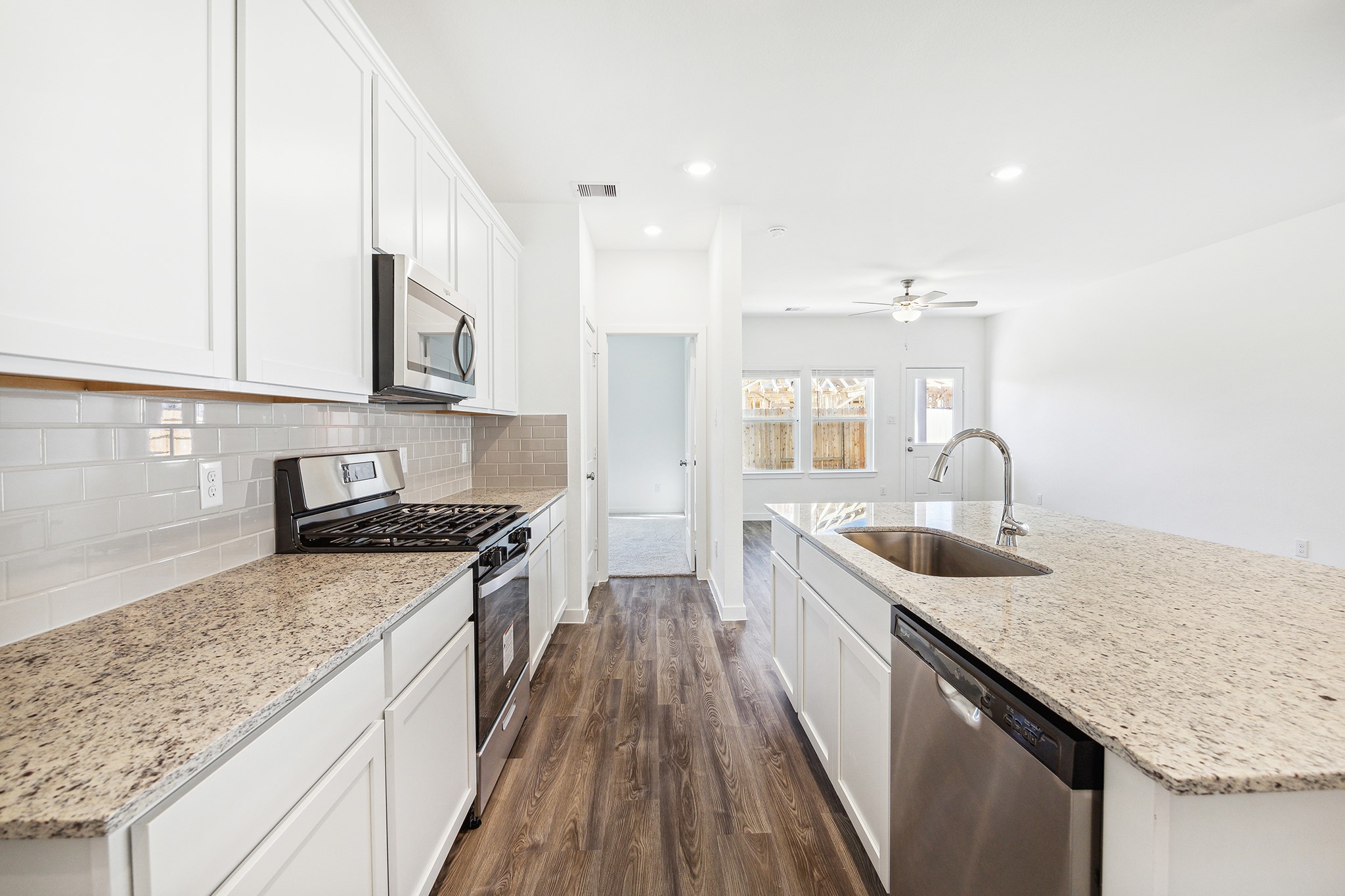 3926 Glory Grn Drive Brookshire, TX 77423 - Photo 7 of 21 a kitchen with stainless steel appliances granite countertop a sink stove and cabinets