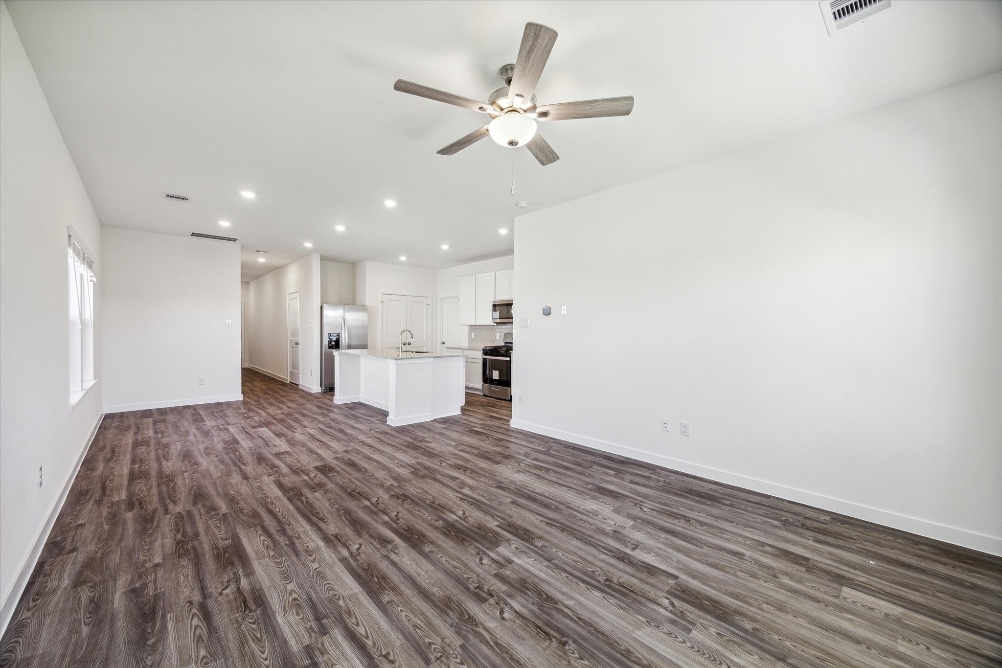 3926 Glory Grn Drive Brookshire, TX 77423 - Photo 10 of 21 a view of a kitchen with a stove and wooden floor