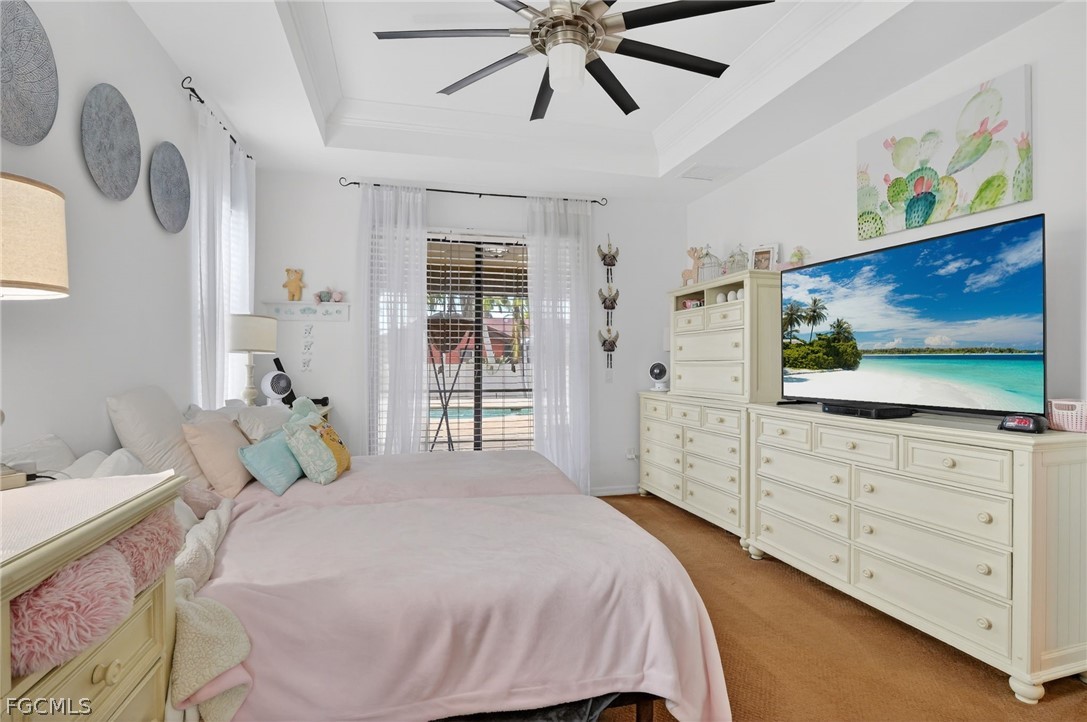 4914 Southwest 25th Court Cape Coral, FL 33914 - Photo 11 of 22 a bedroom with a bed and a flat screen tv